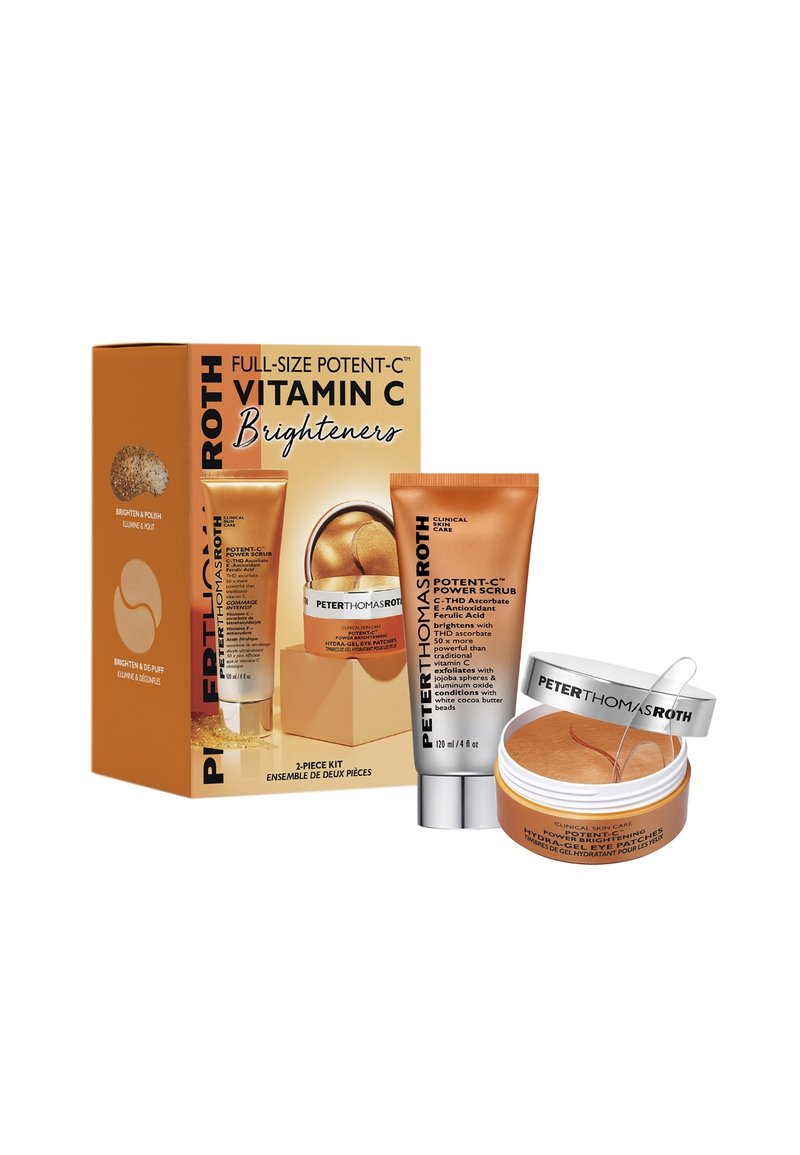 Kit de soins de la peau à la vitamine C dans un emballage orange. Comprend un tube de gommage et un pot de patchs pour les yeux en hydrogel avec une teinte dorée et des détails accentués.