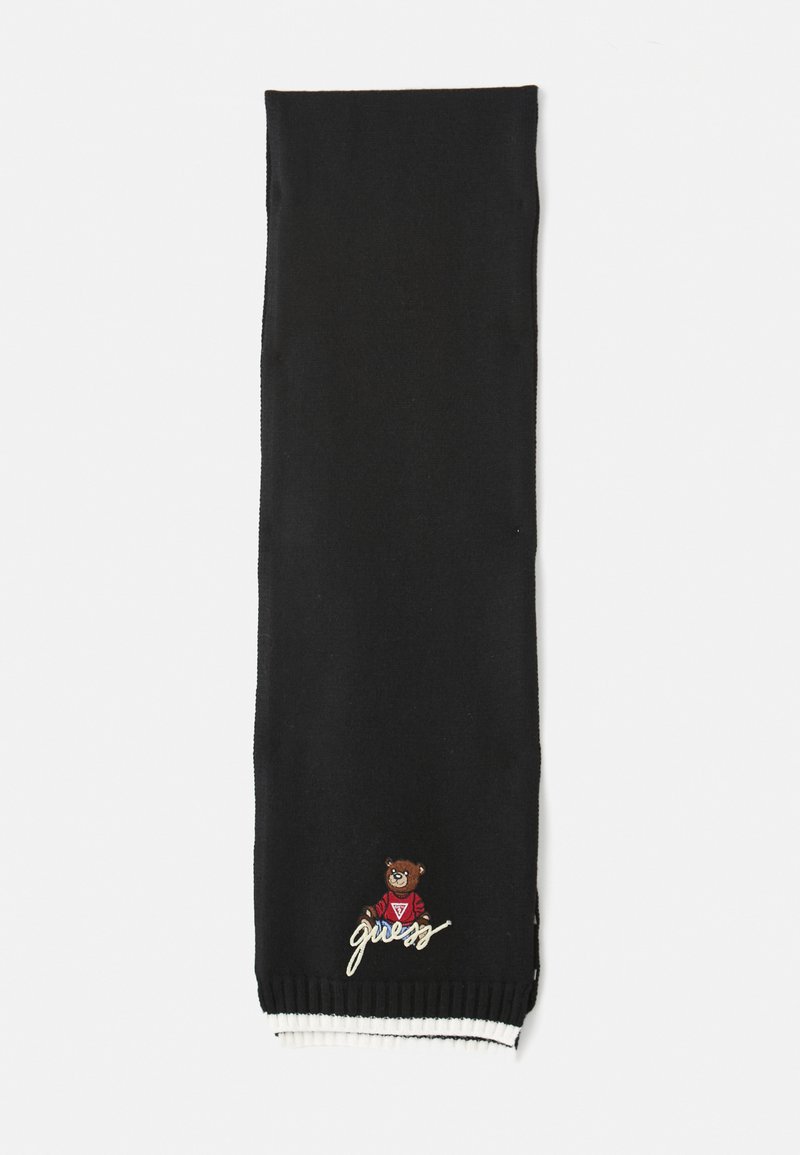 Svart strikket skjerf med et bjørnegrafikk og ordet "guess" brodert i hvitt. Ribbet kant i hvitt og svart. Myk tekstur.