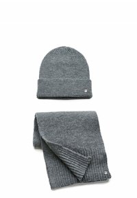 Gray knitted beanie with a ribbed texture sits atop a matching ribbed scarf. Both feature a small brand emblem in silver.
