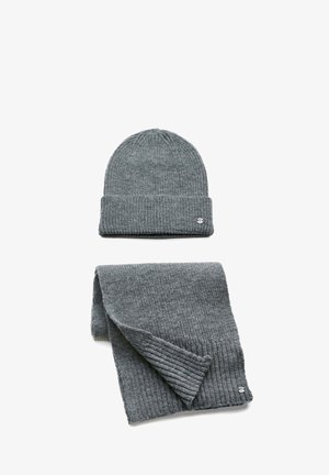 Gray knitted beanie with a ribbed texture sits atop a matching ribbed scarf. Both feature a small brand emblem in silver.