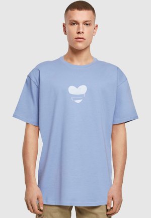 Light blue cotton t-shirt with short sleeves, featuring a white heart graphic at the center. Classic crew neck design.