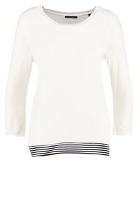 Weißes Langarmshirt mit Rundhalsausschnitt, das am unteren Saum ein gestreiftes Schwarz-Weiß-Muster aufweist. Weicher, glatter Stoff.