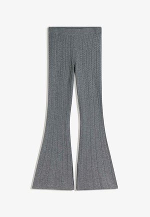 Pantaloni neri a coste con vita alta elastica, caratterizzati da una texture verticale e una ampia apertura sul fondo.