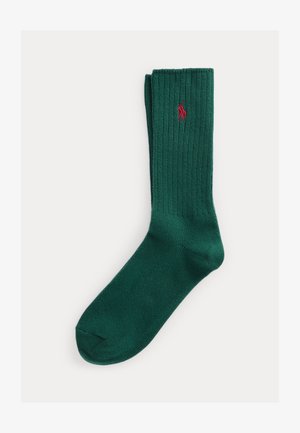 Dark green ribbed sock with red embroidered polo player logo, mid-calf length, folded neatly against white background.