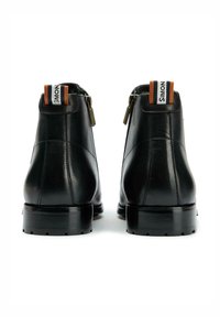 Black leather ankle boots with a smooth texture, including a zipper and a pull tab with orange and white stripe accents. Square toe and low heel.
