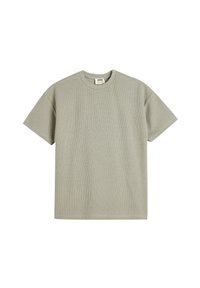 Camiseta de tirantes corta verde claro hecha de tela texturizada con cuello redondo y corte recto, que presenta una pequeña etiqueta de la marca en su interior.