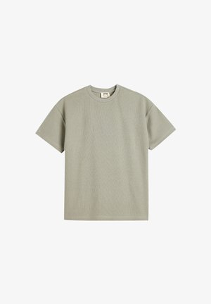 Lysegrøn kortærmet T-shirt lavet af tekstureret stof med rund halsudskæring og lige snit, med et lille mærke indeni.