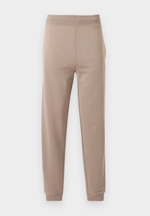 Beige slim-fit joggerbroek met elastische tailleband en enkels, weergegeven tegen een effen witte achtergrond.