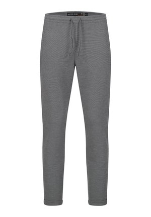 Pantalones de chándal grises hechos de una tela texturizada con cintura ajustable mediante cordón y piernas estrechas, con bajos acentuados y un diseño minimalista.