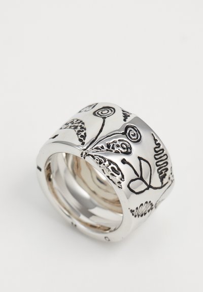 Wide silver ring with black engraved floral and spiral designs on a white background.