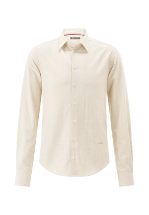 Light beige long-sleeve shirt in a textured fabric with a button-up front, collar, and a curved hem. Features subtle branding near the hem.