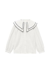 Bela prugasta bluzica s velikim, dvostrukim ovratnikom s crnim cik-cak rubovima. Duži rukavi s kopčanjem na dugmad sprijeda.