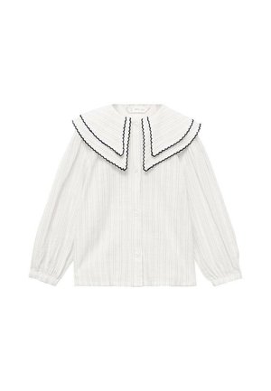 Blusa bianca a righe con un ampio colletto a doppio strato con bordi neri a onda. Maniche lunghe con chiusura a bottoni sul davanti.