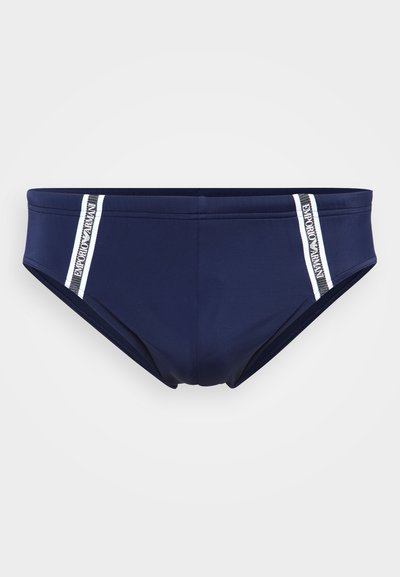 Merehalli ujumispüksid sujuva kangaga, millel on valged külgedel triibud ja tekst "Emporio Armani". Üksikasjalik disain koos elastse vöökohta.