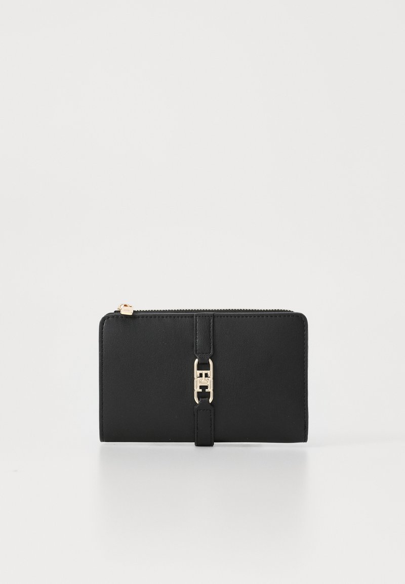 Black leather wallet with a smooth texture, featuring a gold-tone hardware accent and a zip closure. Rectangular shape with a strap detail.