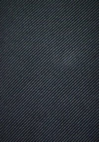 Svart tyg med ett subtilt diagonalt mönster, som har en strukturerad yta som reflekterar ljus och skapar en svag glans.