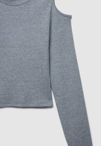 Top lungo a maniche lunghe a coste grigio con design cropped e ritagli sulle spalle. Texture liscia e scollatura rotonda.