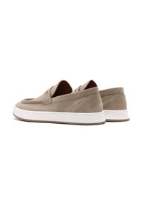 Beige suede slip-on shoes with a rounded toe, featuring two decorative straps on the front and a white rubber sole.