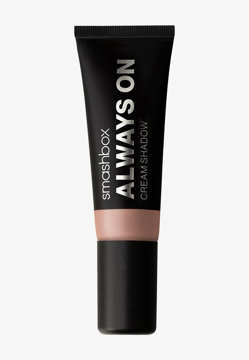 Smashbox Always On Creme-Schattierung in einer schwarzen Tube mit silberner Schrift und einem matten schwarzen Deckel, mit einer sanften rosa Grundfarbe.