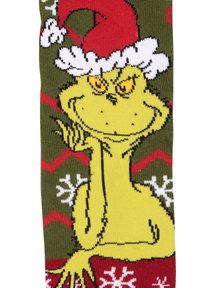 Calzino verde con design del Grinch giallo, che indossa un cappello di Babbo Natale rosso, con fiocchi di neve bianchi e motivi a zigzag in rosso e bianco.