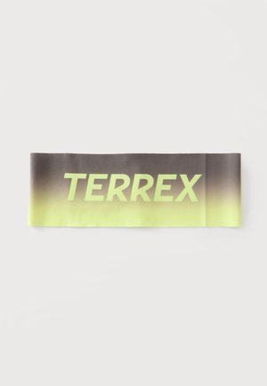 Fascia elastica in tessuto con gradiente dal nero al giallo e la parola "TERREX" stampata con grandi lettere gialle.