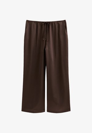 Bruine, wijde broek van gladde stof met een elastische tailleband en een trekkoord, voorzien van twee zijzakken.