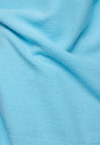 Himmelblauer Strickstoff mit glatter Textur, der feine Rippungen und subtile Wellenmuster auf der gesamten Oberfläche zeigt.