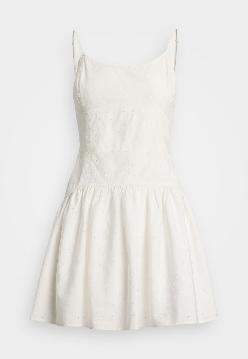 Weißes ärmelloses Kleid mit tailliertem Oberteil, weitem Rock, strukturiertem Stoff, floralem Stickereien und kleinen Aussparungen überall.