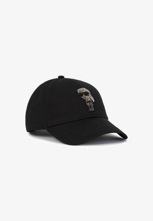 Black baseball cap made of fabric with a curved bill, featuring a jeweled appliqué of a character with sunglasses on the front.