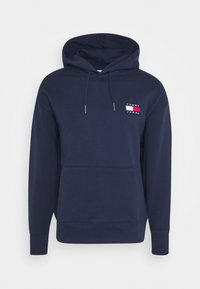 Sudadera azul marino hecha de una mezcla de algodón, con un bolsillo frontal, capucha con cordón y un pequeño parche de logo que presenta acentos en rojo, blanco y azul.