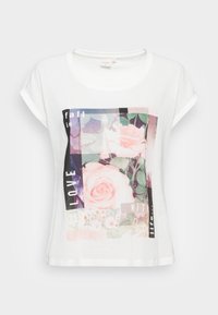 White short-sleeve t-shirt featuring a floral graphic with a pink rose and text elements in black and pastel colors. Soft fabric texture.