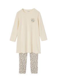 Cremfarbener Langarmshirt mit "FOREVER LOVE" Grafik und schwarzem Herzdesign; kombiniert mit beige Leggings mit schwarzem gepunktetem Muster.