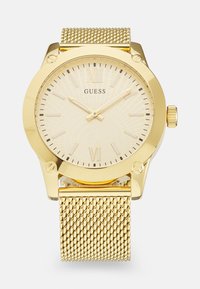 Goldfarbener Mesh-Armbanduhr mit einem strukturierten cremefarbenen Zifferblatt, römischen Ziffern als Markierungen und einem runden goldenen Gehäuse. Verfügt über eine Krone zur Zeiteinstellung.