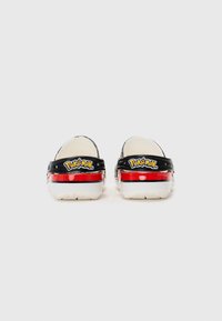 Black and white clogs with a red midsole, featuring "Pokémon" branding on the back and a colorful print throughout.