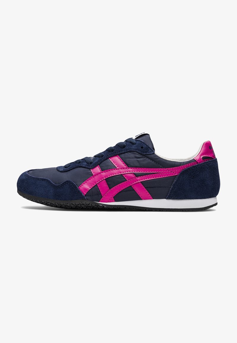 Navy blue athletic shoe with pink accents and suede heel. Features a textured rubber sole and textured fabric upper with lace closure.