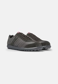 Dark grey sneakers featuring a mix of suede and smooth fabric, with a textured sole and subtle horizontal stripes on the sides.