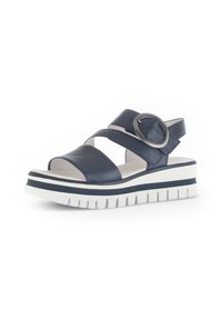 Navy blue leather sandals with wide straps and circular hardware, featuring a white and navy striped platform sole, textured for grip.