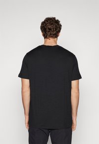 Black short-sleeve t-shirt featuring a crew neck, relaxed fit, and smooth texture, displaying a simple design with no graphics.