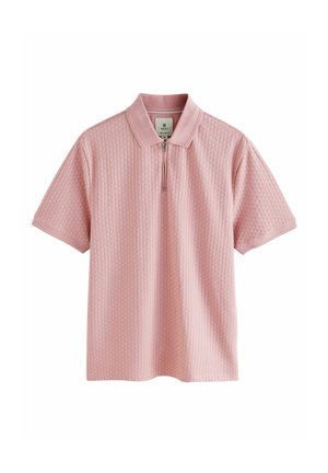 Polo t-shirt i blød pink med et tekstureret, ribbet design. Har en kort lynlås og krave. Korte ærmer.
