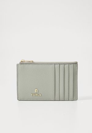 Furla card holder in light grey textured leather, featuring a zip pocket and four card slots, with gold-tone logo detail on the front.