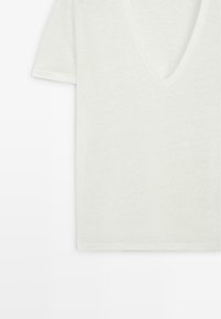 White short-sleeve V-neck T-shirt shown flat with subtle texture on fabric.