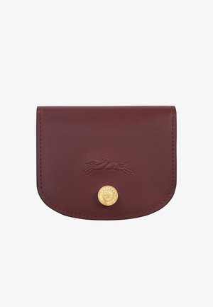 Burgundy leather wallet with embossed running dog logo and round gold button featuring the Longchamp brand name.