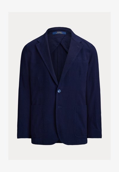 Męska granatowa marynarka sztruksowa z wyłogami z nacięciami, zapinana na jeden guzik, z trzema kieszeniami i metką Polo Ralph Lauren wewnątrz kołnierza.