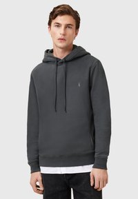 Dunkelgraue Kapuzenjacke aus weichem Stoff, mit einer Kängurutasche, verstellbaren Zugbändern und einem kleinen Logo auf der Brust.