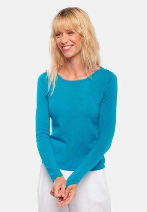 Pull long à manches longues turquoise avec un col rond et des poignets côtelés, fabriqué à partir d'un matériau doux, design ajusté mettant en valeur le torse.