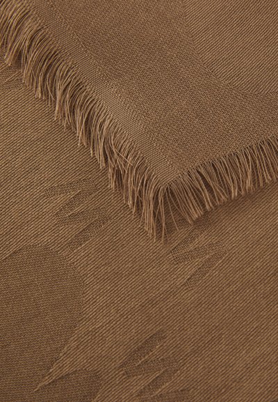 Brown woven fabric with frayed edges, featuring abstract embossed patterns and a smooth texture. Soft, durable material, suitable for various uses.