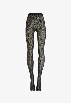 Zwarte panty met kantpatroon en bloemenmotief, verticaal uitgerekt getoond, waarbij de beige achtergrond door de stof zichtbaar is.
