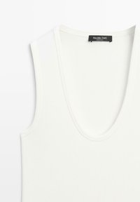 White sleeveless V-neck top with Massimo Dutti label at the back neckline, displayed on a white background.