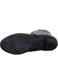 Black leather boot sole with textured floral pattern; features a thick, round heel and smooth upper. Solid, durable construction.