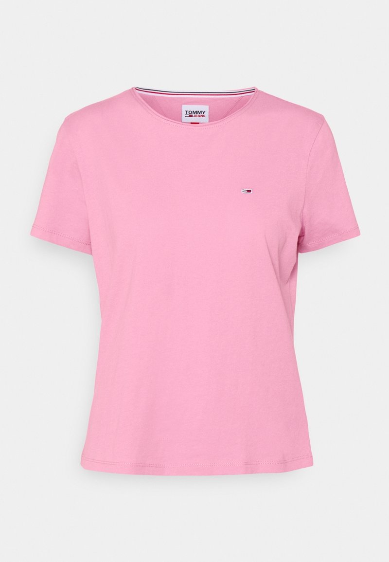 Vaaleanpunainen puuvillapaita, jossa on lyhyet hihat, pyöreä kaula-aukko ja päällekirjaillut logo rinnassa. Pehmeä rakenne ja rento istuvuus.